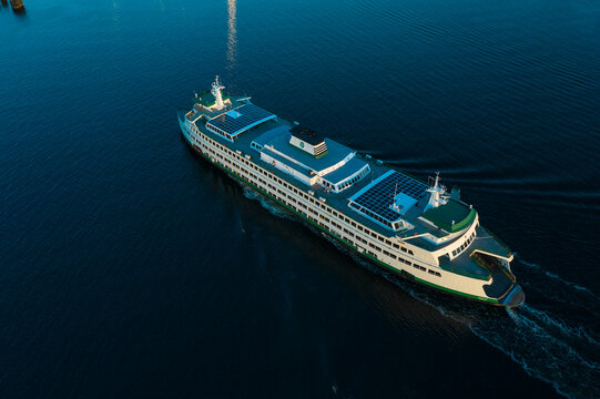 Aerial view of a beautiful washington state ferry navigating through clear turquoise waters of Puget Sound, Edmonds, United States.