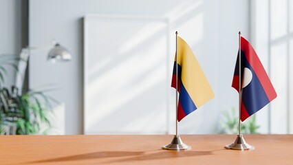 FLAGS OF COLOMBIA AND LAOS ON TABLE