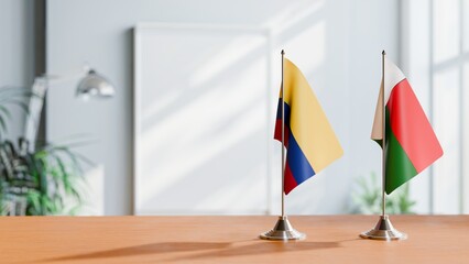 FLAGS OF COLOMBIA AND MADAGASCAR ON TABLE