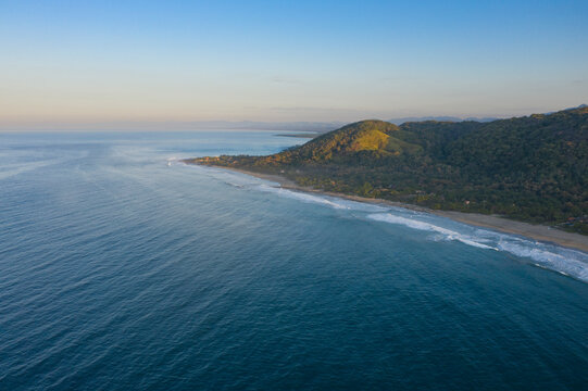Aerial view of beautiful Manzanillo Bay with tranquil Playa Troncones beach and serene ocean waves, Troncones, Mexico.