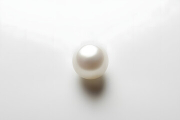 A white egg-shaped light bulb mounted on a wall with a shadow cast