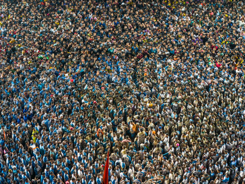 Aerial view of a vibrant crowd celebrating the Dahi Handi festival, Thane, India.