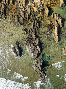 Aerial view of Adan Beach with rocky shore and blue ocean, Kunigami Son, Japan.