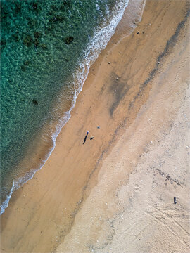 Aerial view of serene Adan Beach with clear blue water and sandy shoreline, Kunigami Son, Japan.