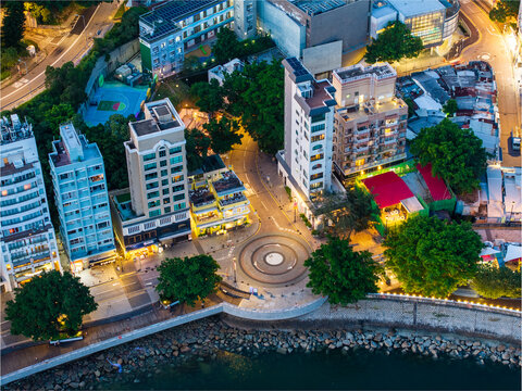 Aerial view of beautiful illuminated cityscape with modern buildings and vibrant nightlife, Chung Hom Kok, Hong Kong.