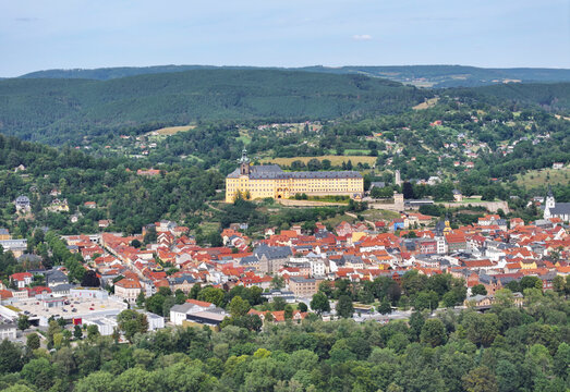 Aerial view of Schloss Heidecksburg castle surrounded by the scenic Thuringian Forest and picturesque town, Rudolstadt, Germany.