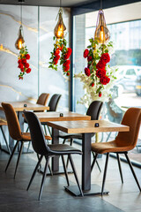 A beautifully designed restaurant interior showcasing a modern and elegant dining area. The space features contemporary furniture, including wooden chairs and tables set with glassware, plates.