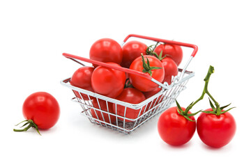 Shopping supermarket basket with fresh ripe organic tomatoes on a branch whole isolated on a white...