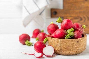 Fresh radish on textured wooden background. Organic natural garden radish slices. clipping root crop. Vegetables. Vegan. Diet products. Healthy food. Place for text. Copy space.