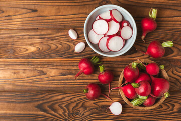 Fresh radish on textured wooden background. Organic natural garden radish slices. clipping root crop. Vegetables. Vegan. Diet products. Healthy food. Place for text. Copy space.