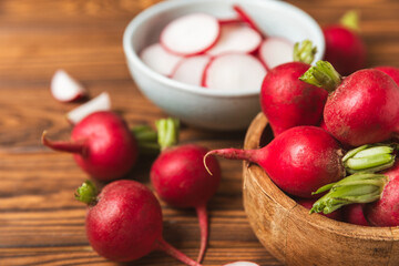 Fresh radish on textured wooden background. Organic natural garden radish slices. clipping root crop. Vegetables. Vegan. Diet products. Healthy food. Place for text. Copy space.