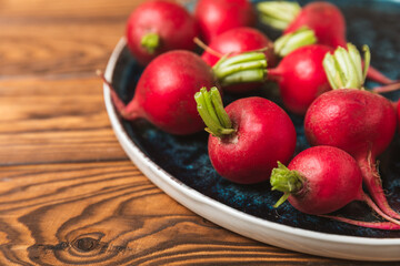 Fresh radish on textured wooden background. Organic natural garden radish slices. clipping root crop. Vegetables. Vegan. Diet products. Healthy food. Place for text. Copy space.