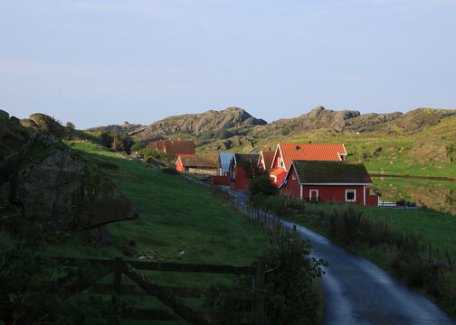 Red houses and rock formations on  Eiger&oslash;ya island, Norway.