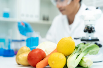 Scientist check chemical food residues in laboratory. Control experts inspect quality of vegetables...