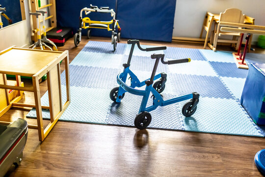 Children engage in physical rehabilitation activities using mobility aids in a cheerful, supportive environment designed for therapy