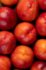 a large number of ripe soft nectarine fruits on the table