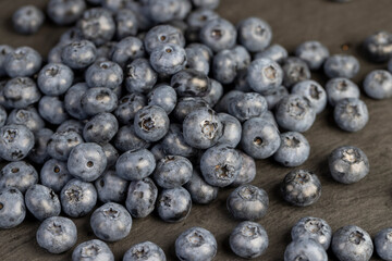a pile of blueberries scattered on the board