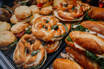 Munich, Germany - September 13, 2024 - A variety of Bavarian-style sandwiches, pretzels with cream...