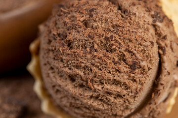 chocolate ice cream in a cone on a board