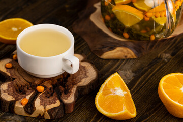 tea with orange and ripe sea buckthorn berries