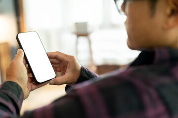 cell phone blank white screen mockup.hand holding texting using mobile on desk at office.background empty space for advertise.work people contact marketing business,technology