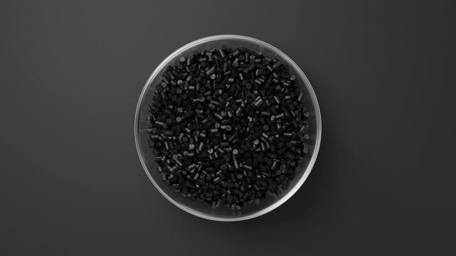 Rotating glass bowl with black plastic polypropylene granules, masterbatch polymer grain on black backdrop. HDPE or PVC resin pellets. 3d render animation