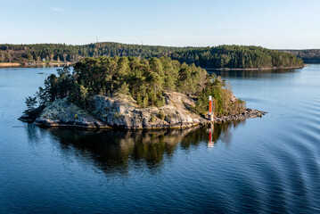 Fototapeta premium Marine signs and lighthouse in the Stockholm archipelago rocky island to help you navigate in shallow water