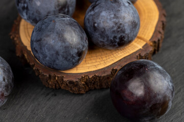ripe purple plum on the table