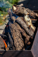 A fire burns in a barbecue grill for cooking shashlik