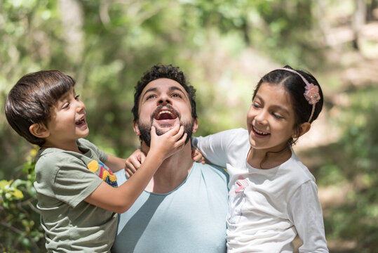 Father playing with his children in forest