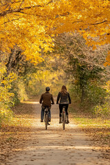 A photo of a couple enjoying a romantic bike ride along a picturesque trail adorned with vibrant fall colors