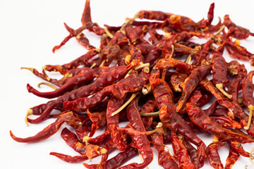 Fototapeta premium Dried peppers on white with a smoky tan color. Garlic above organic concept. Red and red peppers with a green and dried tomatoes in a jar. A white with dried peppers, red peppers, and onions red.