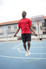 Fototapeta premium Basketball player jumping rope in an outdoors court