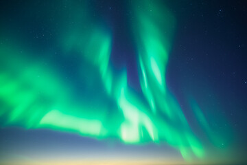 Blue dark sky with green polar lights and stars. Aurora borealis Northern lights in night winter sky