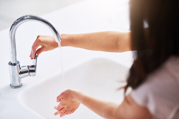 Cleaning, washing hands and water with woman in bathroom of home for hydration, hygiene or skincare. Bacteria, health and wellness with person in apartment for morning or natural dermatology routine