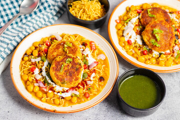 Dabeli is a spicy Indian street food made with a potato filling, tamarind chutney, and sev, served in a bun.