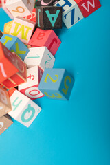 A colorful alphabet blocks scattered on a blue background Perfect for learning and fun