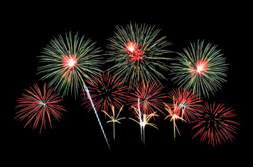 Red and green fireworks exploding on  black sky. Celebration and anniversary concept