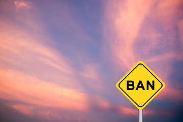 Yellow transportation sign with word ban on violet color sky background