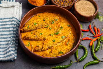A rich, spicy Bengali dish featuring soft pabda fish simmered in a flavorful mustard-tomato gravy.