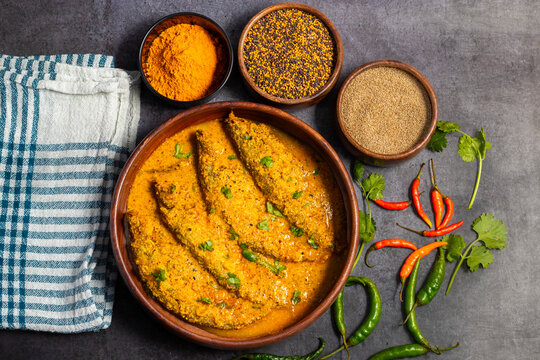 A rich, spicy Bengali dish featuring soft pabda fish simmered in a flavorful mustard-tomato gravy.