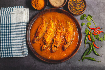 A rich, spicy Bengali dish featuring soft pabda fish simmered in a flavorful mustard-tomato gravy.
