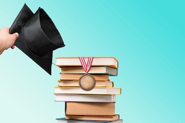 Graduation cap and reading books for education day