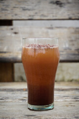 Rich chocolate drink served in a glass with a smooth texture. Beverage concept