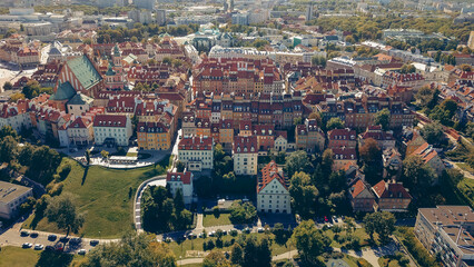 Aerial view of Warsaw's colorful rooftops and historical architecture on a sunny day