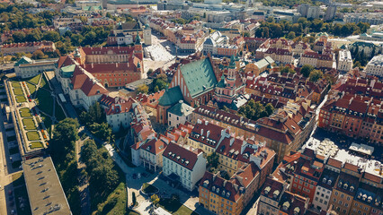 Fototapeta premium Aerial view of Warsaw's historic architecture and vibrant rooftops during a sunny day in late summer