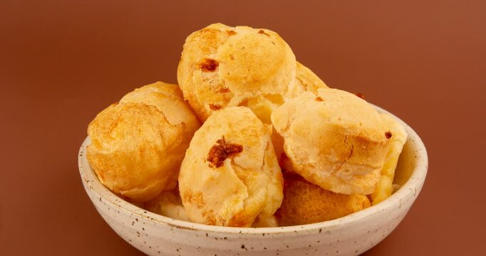Minas Gerais cheese bread balls in a bowl and clean background front view
