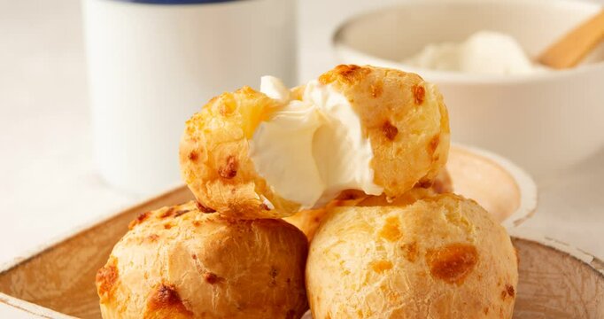 Minas Gerais cheese bread, hot, ina  wooden basket in clean brown background