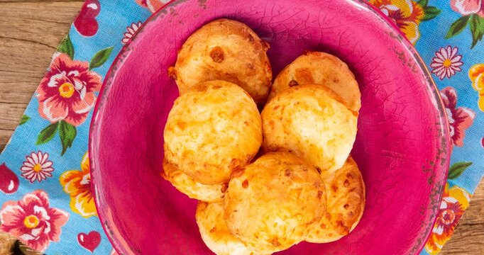Minas Gerais cheese bread balls in a bowl and clean background front view
