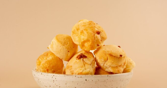 Minas Gerais cheese bread balls in a bowl and clean background front view
